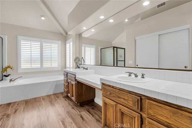 13982 Claremont Ln, Rancho Cucamonga, CA 91739 - full bath with lofted ceiling, double vanity, healthy amount of natural light, a bath, and wood finished floors