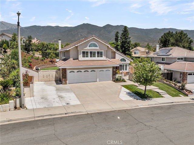 13982 Claremont Ln, Rancho Cucamonga, CA 91739 - traditional-style house featuring a garage, a gate, a mountain view, a tiled roof, and driveway