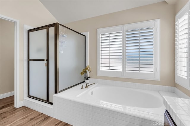13982 Claremont Ln, Rancho Cucamonga, CA 91739 - bathroom featuring a bath, a stall shower, healthy amount of natural light, and wood finished floors