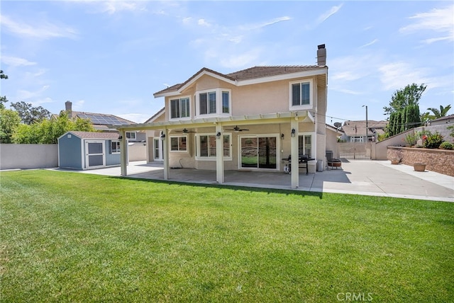 13982 Claremont Ln, Rancho Cucamonga, CA 91739 - rear view of property featuring a storage unit, a fenced backyard, a patio, and a ceiling fan