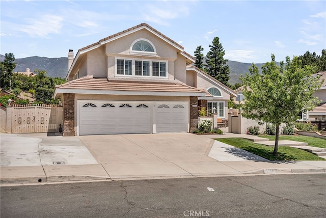 13982 Claremont Ln, Rancho Cucamonga, CA 91739 - traditional-style house with an attached garage, a mountain view, stucco siding, concrete driveway, and a tile roof