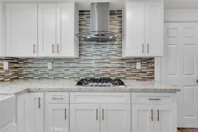 13982 Claremont Ln, Rancho Cucamonga, CA 91739 - kitchen featuring wall chimney range hood, stainless steel gas stovetop, white cabinets, and backsplash