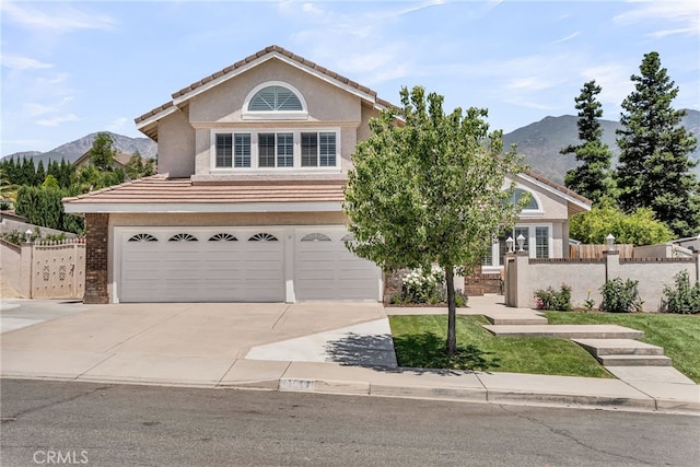 13982 Claremont Ln, Rancho Cucamonga, CA 91739 - view of front facade featuring a garage, stucco siding, concrete driveway, a mountain view, and a tiled roof