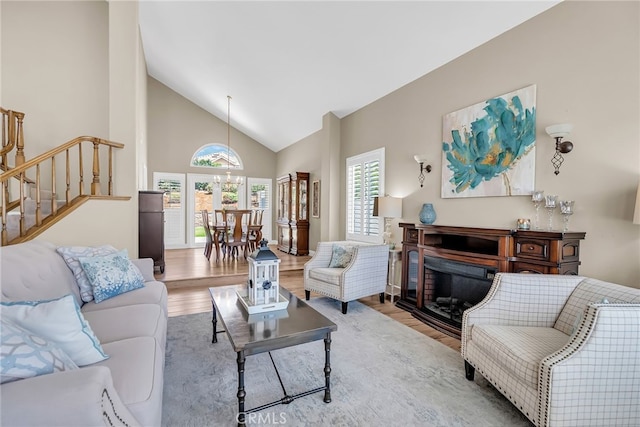 13982 Claremont Ln, Rancho Cucamonga, CA 91739 - living area with high vaulted ceiling, wood finished floors, stairs, and a fireplace