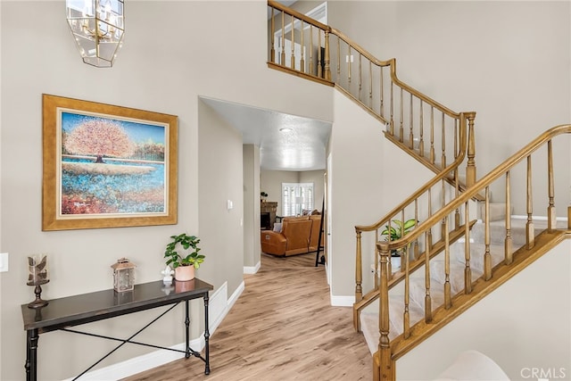 13982 Claremont Ln, Rancho Cucamonga, CA 91739 - foyer with stairway, wood finished floors, a towering ceiling, and a chandelier