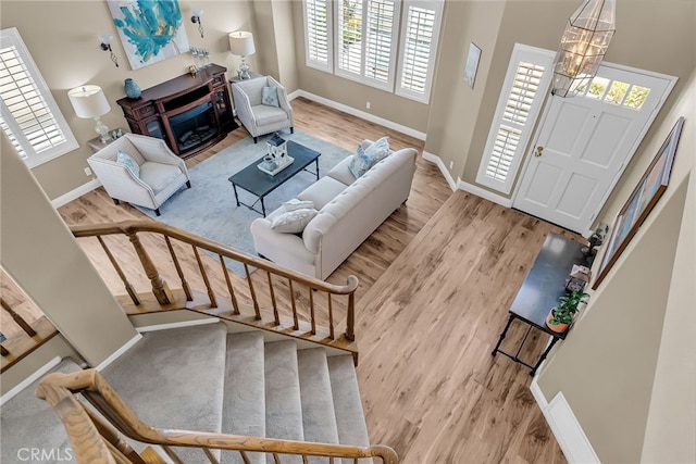 13982 Claremont Ln, Rancho Cucamonga, CA 91739 - living room featuring wood finished floors, plenty of natural light, a chandelier, and stairs