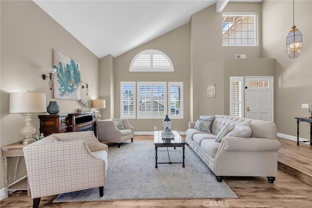 13982 Claremont Ln, Rancho Cucamonga, CA 91739 - living room featuring wood finished floors, high vaulted ceiling, and plenty of natural light