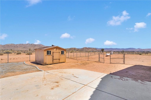 15090 Olema Rd, Apple Valley, CA 92307 - view of yard featuring a mountain view, a storage shed, and a view of countryside