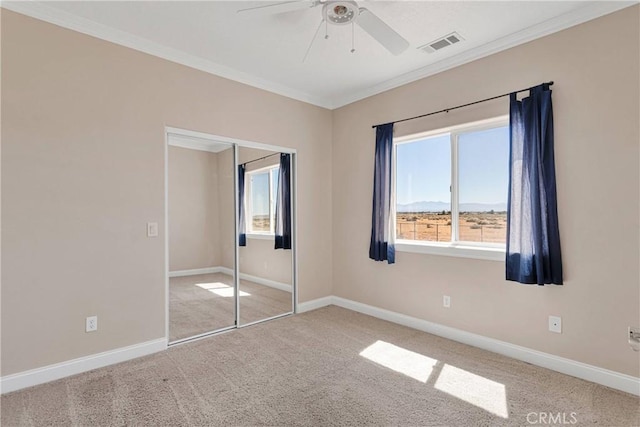 15090 Olema Rd, Apple Valley, CA 92307 - unfurnished bedroom with ornamental molding, carpet floors, a closet, ceiling fan, and a mountain view