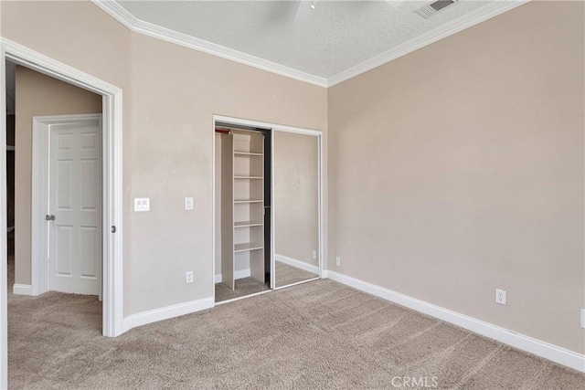 15090 Olema Rd, Apple Valley, CA 92307 - unfurnished bedroom featuring carpet floors, crown molding, a closet, and a textured ceiling