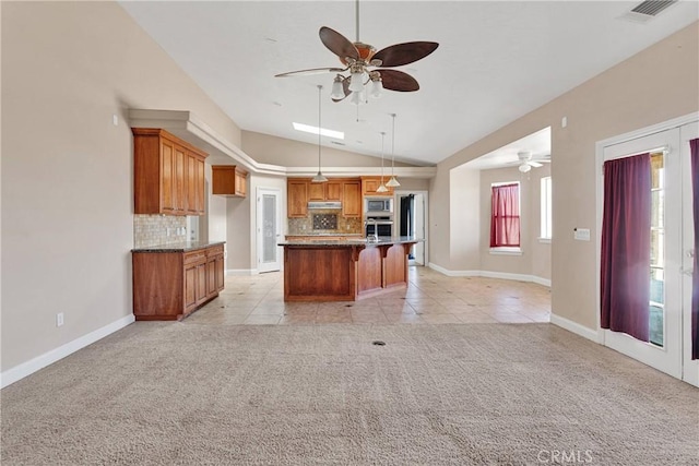15090 Olema Rd, Apple Valley, CA 92307 - kitchen with stainless steel appliances, ceiling fan, vaulted ceiling, light colored carpet, and backsplash