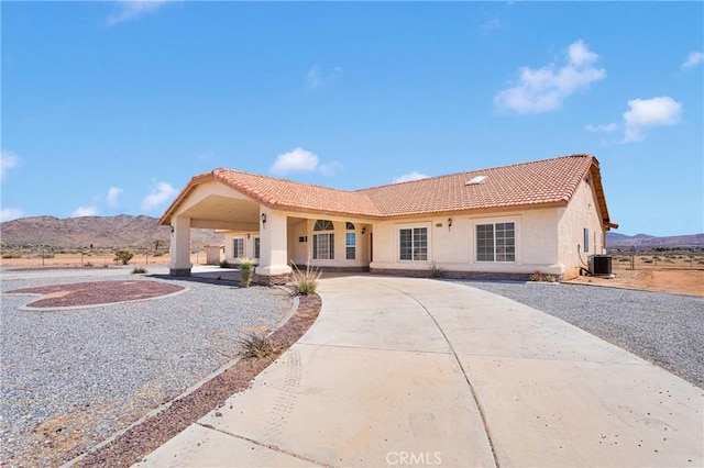 15090 Olema Rd, Apple Valley, CA 92307 - back of property featuring a tile roof, stucco siding, a mountain view, and curved driveway