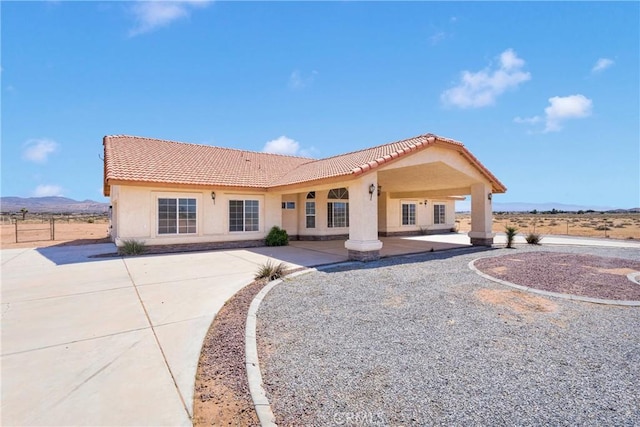 15090 Olema Rd, Apple Valley, CA 92307 - rear view of house featuring a tile roof, stucco siding, a patio area, and a mountain view