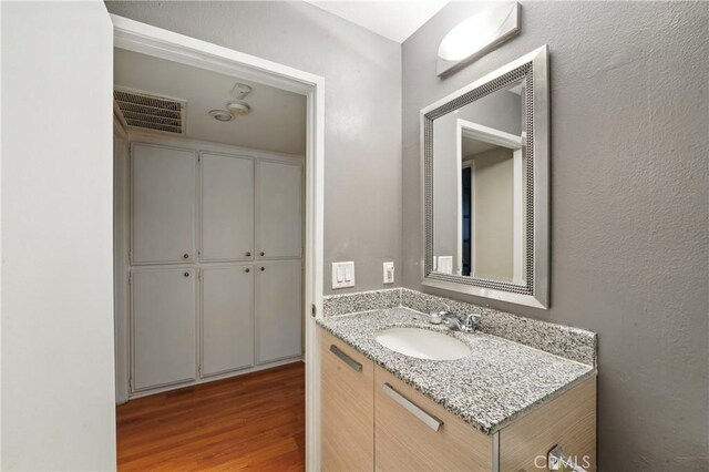 6250 Fulton Ave Unit 104, Van Nuys, CA 91401 - bathroom with wood finished floors and vanity