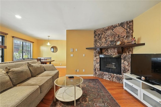 6250 Fulton Ave Unit 104, Van Nuys, CA 91401 - living area featuring wood finished floors and a stone fireplace
