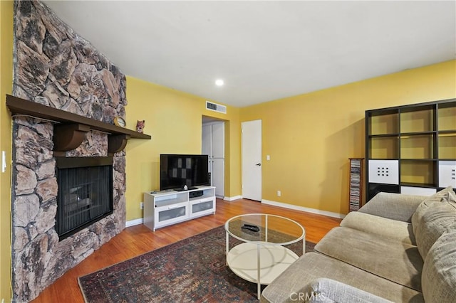 6250 Fulton Ave Unit 104, Van Nuys, CA 91401 - living area featuring a stone fireplace, wood finished floors, and recessed lighting