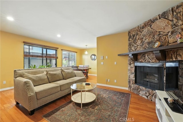 6250 Fulton Ave Unit 104, Van Nuys, CA 91401 - living area featuring wood finished floors, recessed lighting, and a stone fireplace