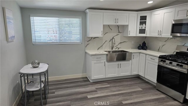 2108 Raleigh Ave, Costa Mesa, CA 92627 - kitchen featuring appliances with stainless steel finishes, white cabinetry, decorative backsplash, recessed lighting, and glass insert cabinets