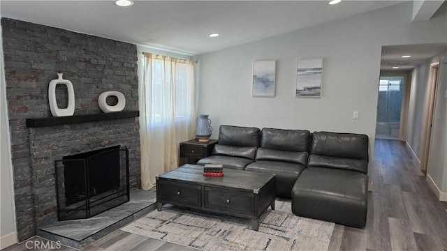 2108 Raleigh Ave, Costa Mesa, CA 92627 - living room with wood finished floors, vaulted ceiling, a fireplace, and recessed lighting
