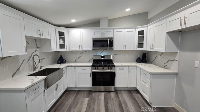 2108 Raleigh Ave, Costa Mesa, CA 92627 - kitchen with appliances with stainless steel finishes, vaulted ceiling, white cabinets, glass insert cabinets, and dark wood-type flooring
