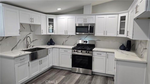 2108 Raleigh Ave, Costa Mesa, CA 92627 - kitchen featuring appliances with stainless steel finishes, lofted ceiling, white cabinetry, dark wood finished floors, and glass insert cabinets