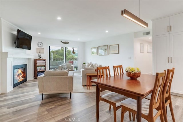 2501 S El Camino Real Unit 310, San Clemente, CA 92672 - dining room with light wood-type flooring, recessed lighting, and a glass covered fireplace