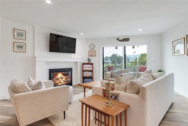 2501 S El Camino Real Unit 310, San Clemente, CA 92672 - living area with light wood-style floors, a glass covered fireplace, and recessed lighting