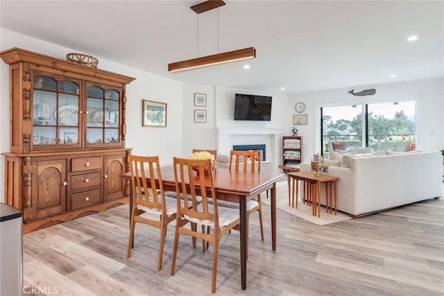 2501 S El Camino Real Unit 310, San Clemente, CA 92672 - dining space with light wood-style floors, a fireplace, and recessed lighting