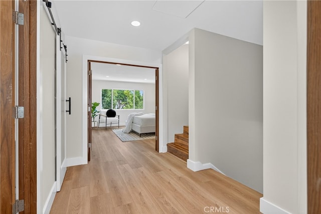 913 Lindencliff St, Torrance, CA 90502 - hall featuring a barn door, light wood-style flooring, and recessed lighting