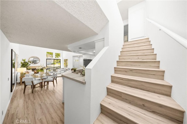45 Briarglen Unit 64, Irvine, CA 92614 - stairway with wood finished floors and a textured ceiling