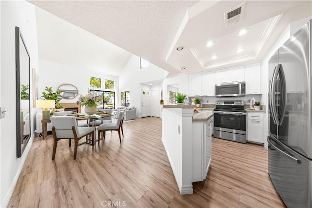 45 Briarglen Unit 64, Irvine, CA 92614 - kitchen featuring stainless steel appliances, light wood-style flooring, white cabinetry, light countertops, and recessed lighting