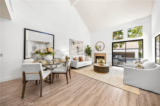 45 Briarglen Unit 64, Irvine, CA 92614 - living area with high vaulted ceiling, wood finished floors, a fireplace, and beamed ceiling