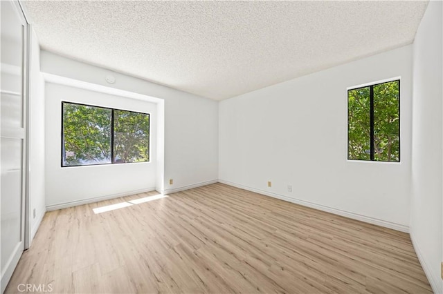 45 Briarglen Unit 64, Irvine, CA 92614 - spare room featuring light wood finished floors and a textured ceiling