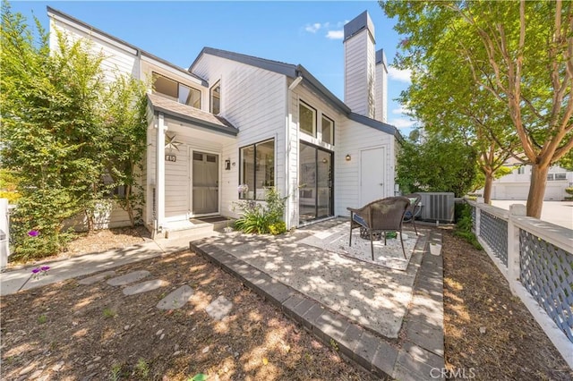 45 Briarglen Unit 64, Irvine, CA 92614 - back of house featuring a chimney and a patio