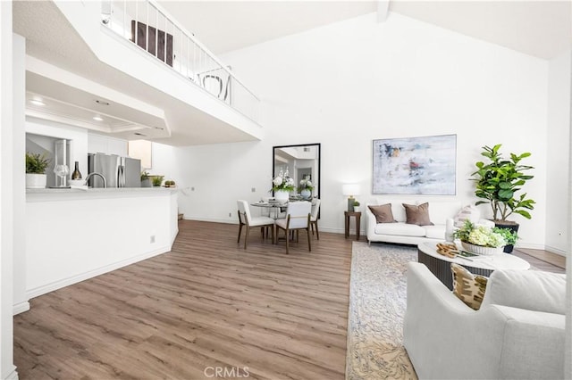 45 Briarglen Unit 64, Irvine, CA 92614 - living area featuring light wood-type flooring, recessed lighting, high vaulted ceiling, and beamed ceiling