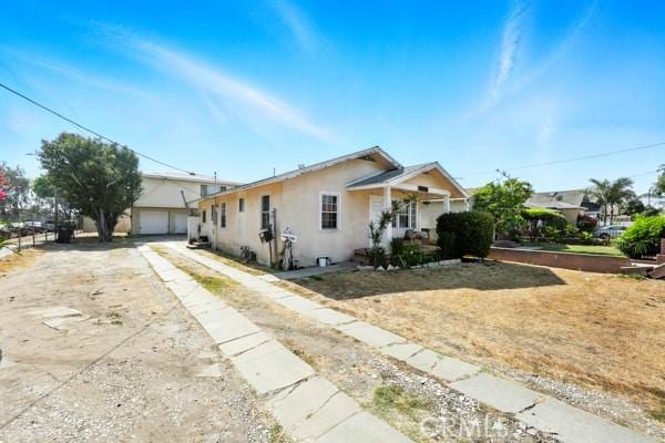11156 S Grevillea Ave, Hawthorne, CA 90304 - view of front of property with stucco siding and a detached garage