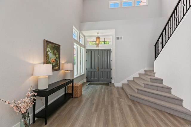 4470 Caminito Tecera, Del Mar, CA 92014 - foyer entrance featuring a high ceiling, stairs, and wood finished floors