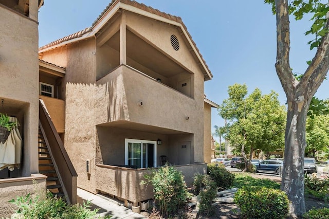 214 Woodland Pkwy Unit 206, San Marcos, CA 92069 - rear view of property featuring stairs and stucco siding