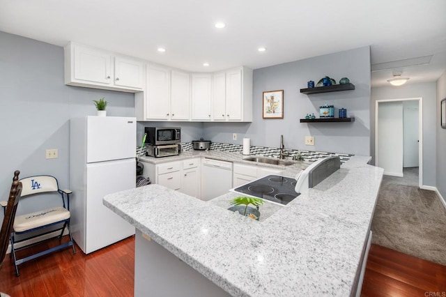 214 Woodland Pkwy Unit 206, San Marcos, CA 92069 - kitchen featuring white appliances, a peninsula, light stone counters, white cabinets, and recessed lighting