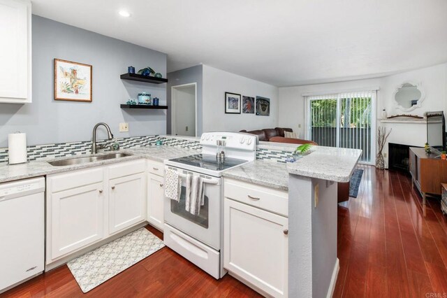 214 Woodland Pkwy Unit 206, San Marcos, CA 92069 - kitchen featuring white appliances, a peninsula, white cabinets, dark wood-style floors, and light stone counters