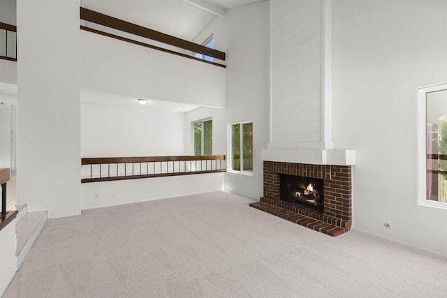 13443 Black Hills Rd, San Diego, CA 92129 - unfurnished living room featuring a brick fireplace, carpet flooring, high vaulted ceiling, and beam ceiling