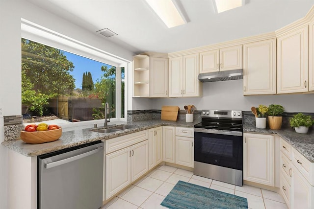 13443 Black Hills Rd, San Diego, CA 92129 - kitchen with stainless steel appliances, under cabinet range hood, cream cabinets, and light tile patterned floors