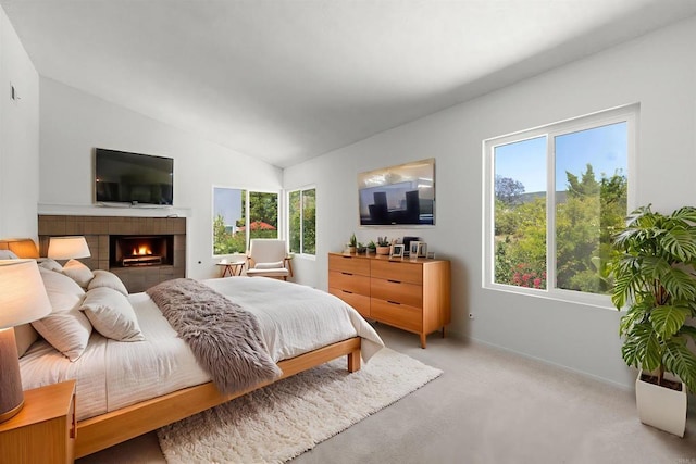 13443 Black Hills Rd, San Diego, CA 92129 - bedroom with vaulted ceiling, a tiled fireplace, and light carpet