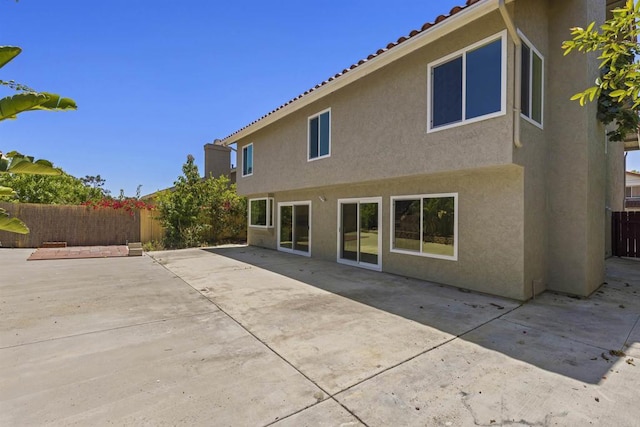13443 Black Hills Rd, San Diego, CA 92129 - rear view of property featuring stucco siding, a fenced backyard, a tiled roof, and a patio area