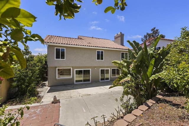 13443 Black Hills Rd, San Diego, CA 92129 - rear view of house featuring stucco siding, a chimney, a patio, and a tile roof