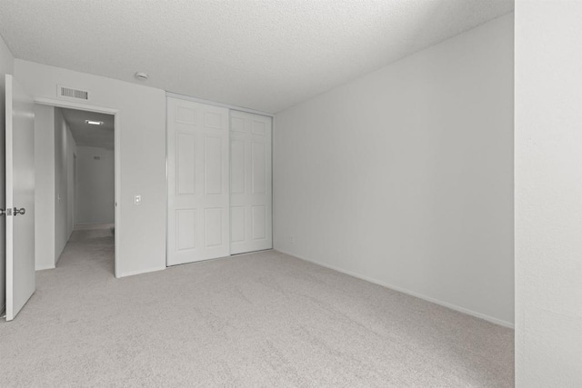13443 Black Hills Rd, San Diego, CA 92129 - unfurnished bedroom with light carpet, a closet, and a textured ceiling