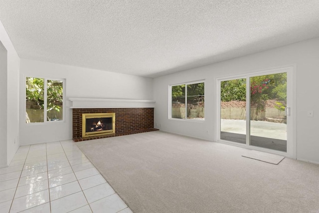 13443 Black Hills Rd, San Diego, CA 92129 - unfurnished living room featuring a textured ceiling, a fireplace, light tile patterned floors, and light carpet