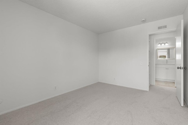 13443 Black Hills Rd, San Diego, CA 92129 - spare room with light colored carpet and a textured ceiling