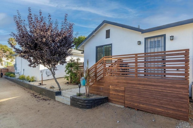 376378 Acacia Dr, Carlsbad, CA 92008 - view of side of home featuring stucco siding and a deck