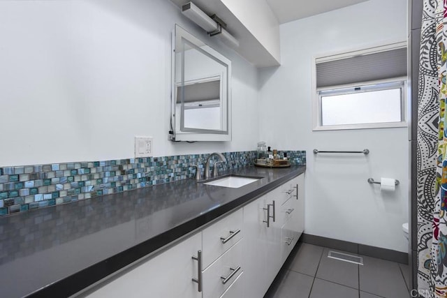 1001 Ontario St, Escondido, CA 92025 - bathroom with vanity, tile patterned flooring, and backsplash